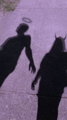 the shadow of two people holding hands with a hat on top of their head,