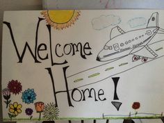 a welcome home sign with an airplane painted on it