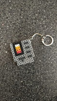 a lego keychain with an image of a pacman on it