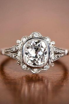 an antique style diamond ring on a wooden table