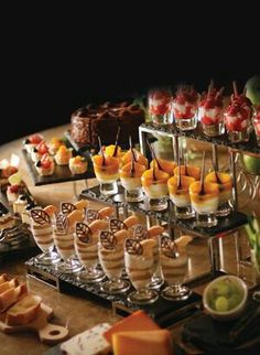 a table topped with lots of different types of desserts and pastries on top of it