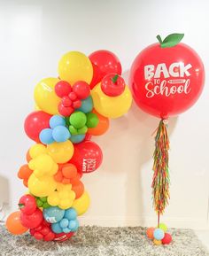 an apple and balloon arch for back to school