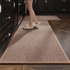 a woman in high heels is standing on the kitchen floor