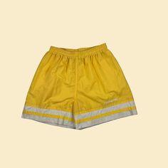 Vintage women's athletic shorts, manufactured ca. 1980s-1990s by Reebok. Yellow & white shorts with an elastic waist and drawstring. Women's size M.   - Time Period: c. 1980s-1990s  - Brand: Reebok  - Size: M  - Colors: Yellow, white  - Materials: 100% nylon  - Made in: USA  - Condition: In fair, vintage condition. There is a hole on the interior of the hem where it reveals the drawstring (note - not visible on exterior), and there is pilling throughout. The pilling is more prominent on the interior, but there are some spots on the exterior (see close-ups). The brand tag was ripped out on the interior. Measurements:   - Outer seam: 16.25"  - Inseam: 3.75"   - Waist: 12.5"   - Hips: 21.5"   - Rise: 13.5"   - Hem: 13.5"  Note: our measurements are taken with clothing laid flat. We do not dou Interior Measurements, Womens Athletic Shorts, Vintage Sport, Time Period, Vintage Sports, Brand Tags, Athletic Shorts, True Vintage, Workout Shorts