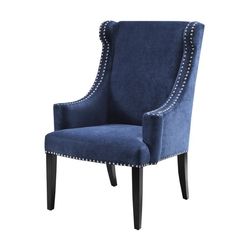 an upholstered blue chair with studded trimmings on the arms and legs