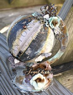 an old globe is sitting on a wooden bench