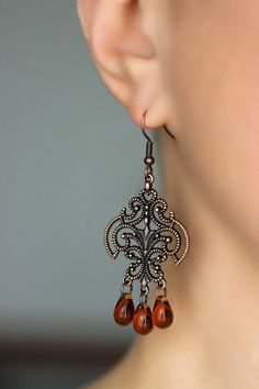 These beautiful boho earrings was made of tea color czech glass drop beads, copper chandelier charms, copper jumping rings and copper earrings hooks. Earrings hooks are from nickel free and lead free metal. Perfec for your unique outfit and a great gift for someone special! *The total lenght of earrings is about 63 mm including earring hooks. Other earrings of my shop you can see here: https://www.etsy.com/shop/NaTavelli?section_id=13757927 Thanks for visit. Vintage Brown Earrings With Dangling Beads, Vintage Brown Beaded Dangle Earrings, Brown Czech Glass Beaded Drop Earrings, Bohemian Brown Teardrop Earrings For Gift, Bohemian Brown Teardrop Earrings Gift, Brown Czech Glass Earrings With Dangling Beads, Bohemian Brown Drop Chandelier Earrings, Elegant Copper Earrings With Dangling Beads, Bohemian Brown Teardrop Earrings For Pierced Ears