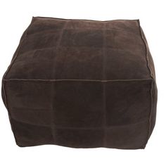 a brown square footstool sitting on top of a white floor