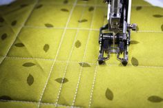 the sewing machine is sitting on the yellow fabric