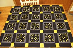 a table with a black and yellow quilt on it