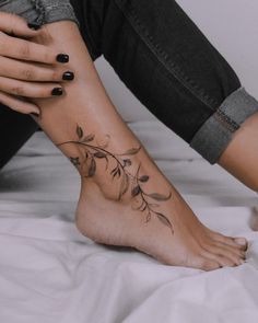 a woman's foot with leaves on it