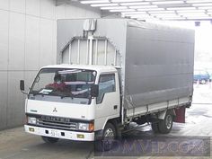 a white truck parked in front of a building