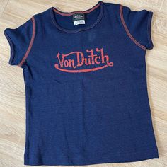 Von Dutch Short Sleeve T-Shirt Girls Size 6, In Navy Blue With Orange Contrast Stitching And Lettering, Nwot 100% Cotton Von Dutch Clothes, 1990 Clothes, Von Dutch Top, Thrifting Manifestation, Dream Closet Clothes, Sweat Tour, Dutch Clothing, September Fashion, Dutch Blue