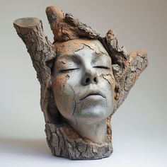 a ceramic head that has been made to look like a tree stump