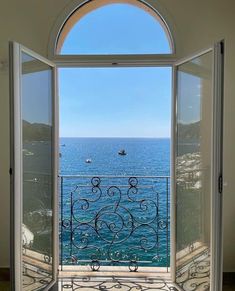 an open window looking out at the ocean