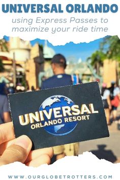 a person holding up a business card with the words universal resort in front of them