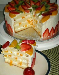 there is a cake that has been cut into pieces and served on the plate with strawberries