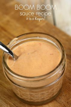 a spoon sticking out of a jar filled with sauce