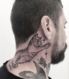 a man with a cat tattoo on his neck