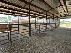 an enclosed area with several stalls for horses