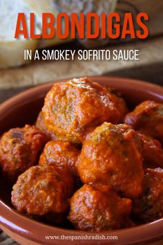 some meatballs are in a bowl with sauce on top and the words spanish - style smokey meatballs above it