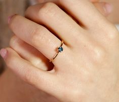 a close up of a person's hand with a ring on it