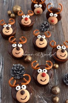 chocolate cupcakes decorated with reindeer faces and pine cones