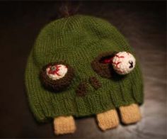 a green knitted hat with two holes in the middle