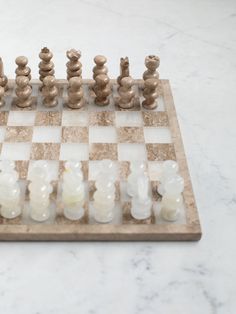 a marble chess board with white pieces on it