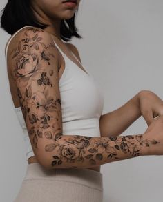 a woman with tattoos on her arms and arm