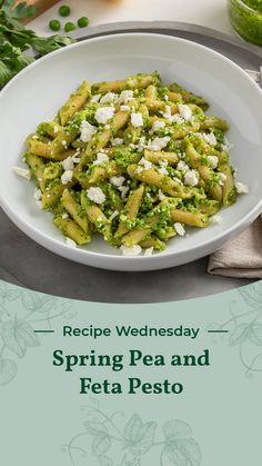 a white plate topped with pasta and pesto