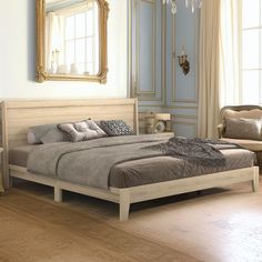 a large bed sitting in a bedroom on top of a hard wood floor