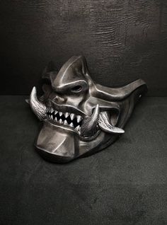 a metal mask with teeth and fangs on it