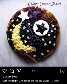 a plate topped with fruit and stars on top of a white tablecloth covered surface