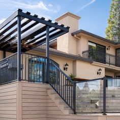 an outside view of a house with a metal railing and stairs leading up to the second floor