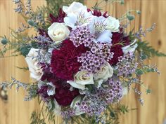 a bridal bouquet with white and red flowers