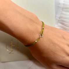 Experience enduring sophistication with our String Bracelet for Women—a delicate masterpiece embellished with 14k gold clips and solid 18k gold beads. This minimalist wish bracelet embodies understated luxury, perfect for solo wear, providing a delicate touch, or stacked to make a bold statement of friendship and style. Made from Solid 18k Gold Bead and 14k Gold Clips Waterproof jewelry Adjustable size 9 color options Gift packaging Quality certificate FREE shipping worldwide Bead size 3mm This Adjustable Gold Bracelets With Sterling Silver Clasp, Gold Bracelets With Sterling Silver Clasp For Everyday, Gold Bracelet With Sterling Silver Clasp For Everyday, Elegant White Gold Friendship Bracelets, Classic Bracelets With Tiny Beads For Everyday, Everyday Beaded 14k Gold Bracelets, Modern Everyday Jewelry With Tiny Beads, Modern Jewelry With Tiny Beads, Classic Jewelry With Tiny Beads For Everyday