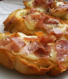 two pieces of bread topped with ham and cheese