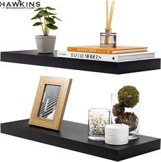 two black shelves with books and plants on them