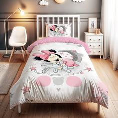 a bed with minnie mouse on it in a bedroom