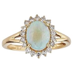 an oval opal and diamond ring in yellow gold