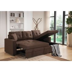 a brown sectional sofa with pull out bed in front of a window and rug on the floor