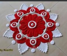 a red and white flower design on the floor