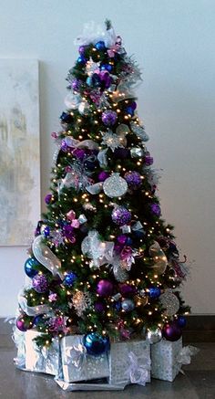 a decorated christmas tree with presents under it