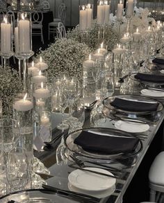 a long table is set with candles and plates