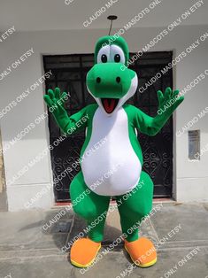 an inflatable green and white dinosaur mascot standing on the sidewalk with his hands up