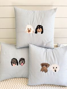 three pillows with dogs embroidered on them