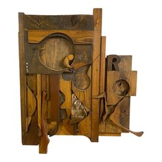 an art piece made out of wood with various tools attached to the back of it