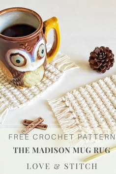 an owl mug sitting on top of a table next to a knitted coaster