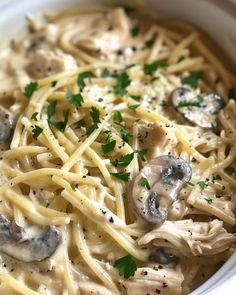 a white bowl filled with pasta and mushrooms